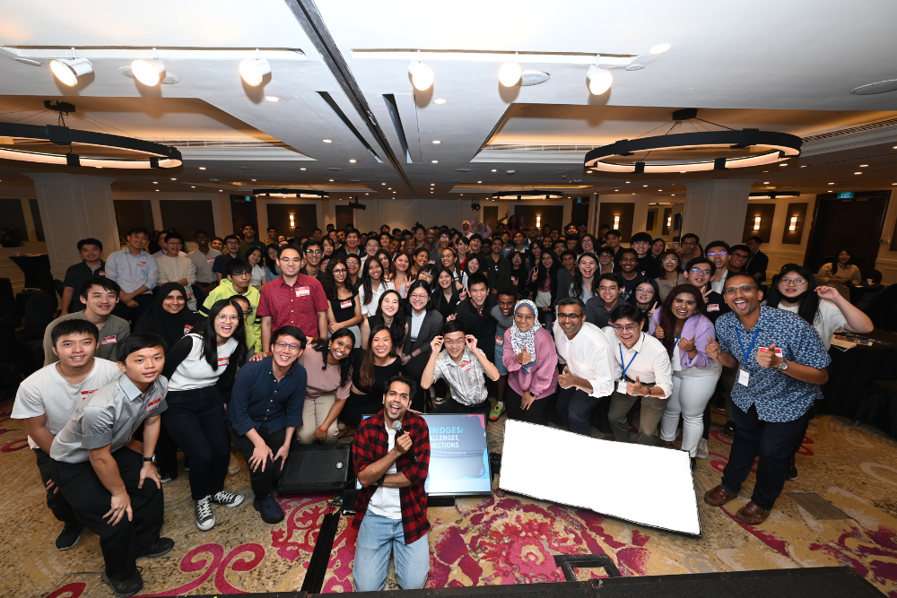 Large group of people posing for photo indoors